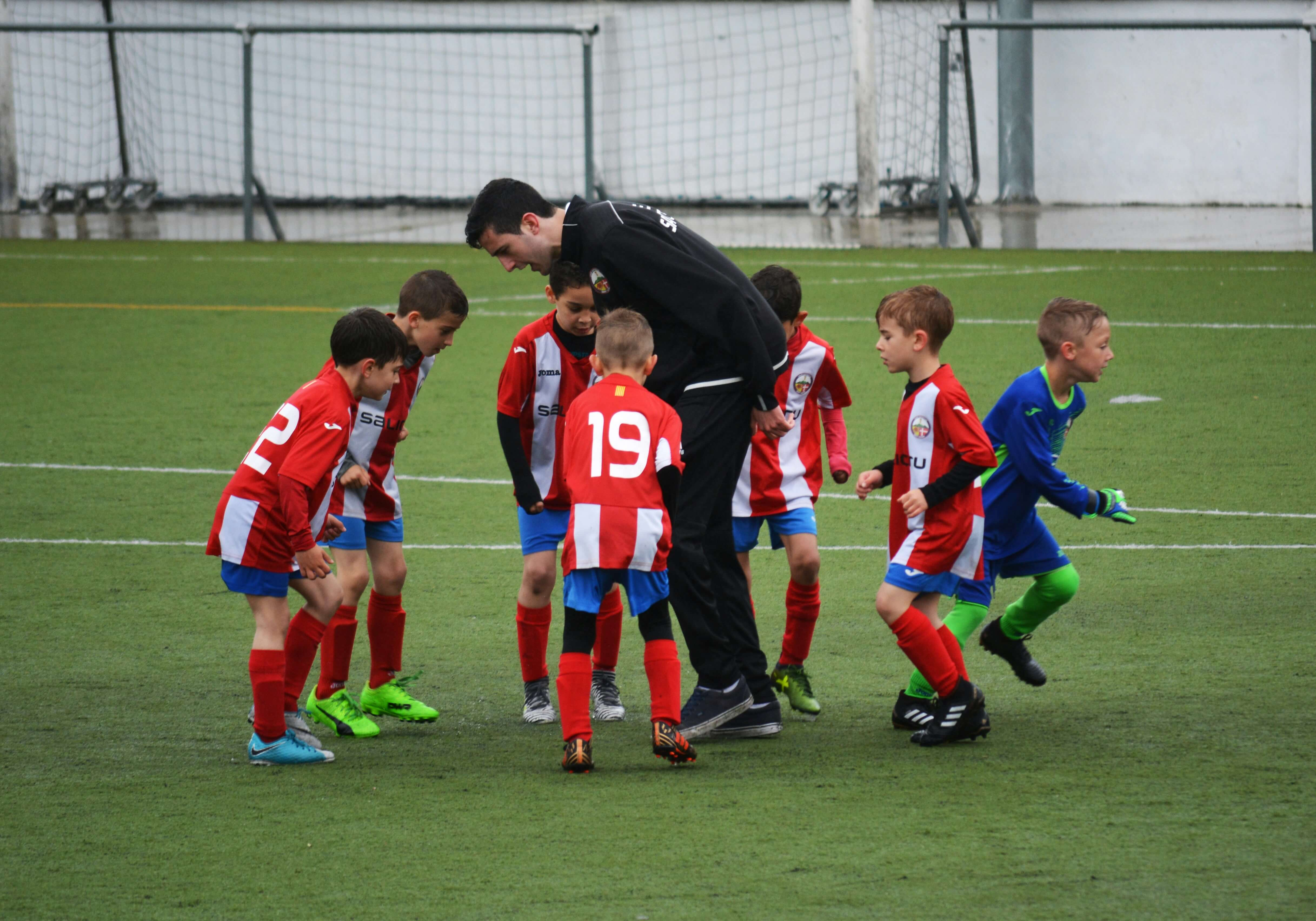 Youth football players high-fiving after successful play