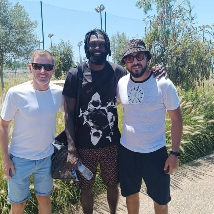 Football team celebrating a goal together on the pitch