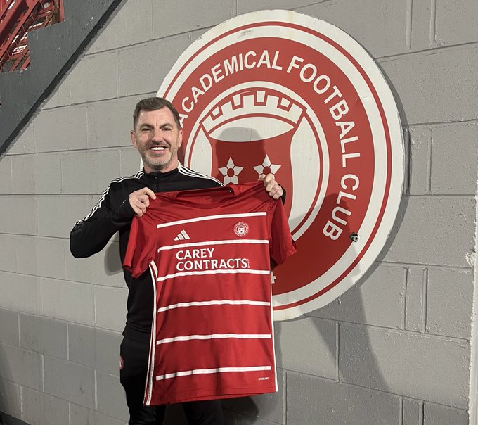 Youth football players high-fiving after successful play